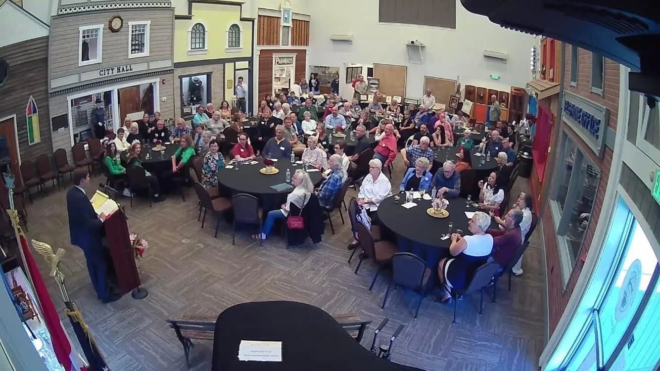 Guests seated at round tables during an event in the Great Hall